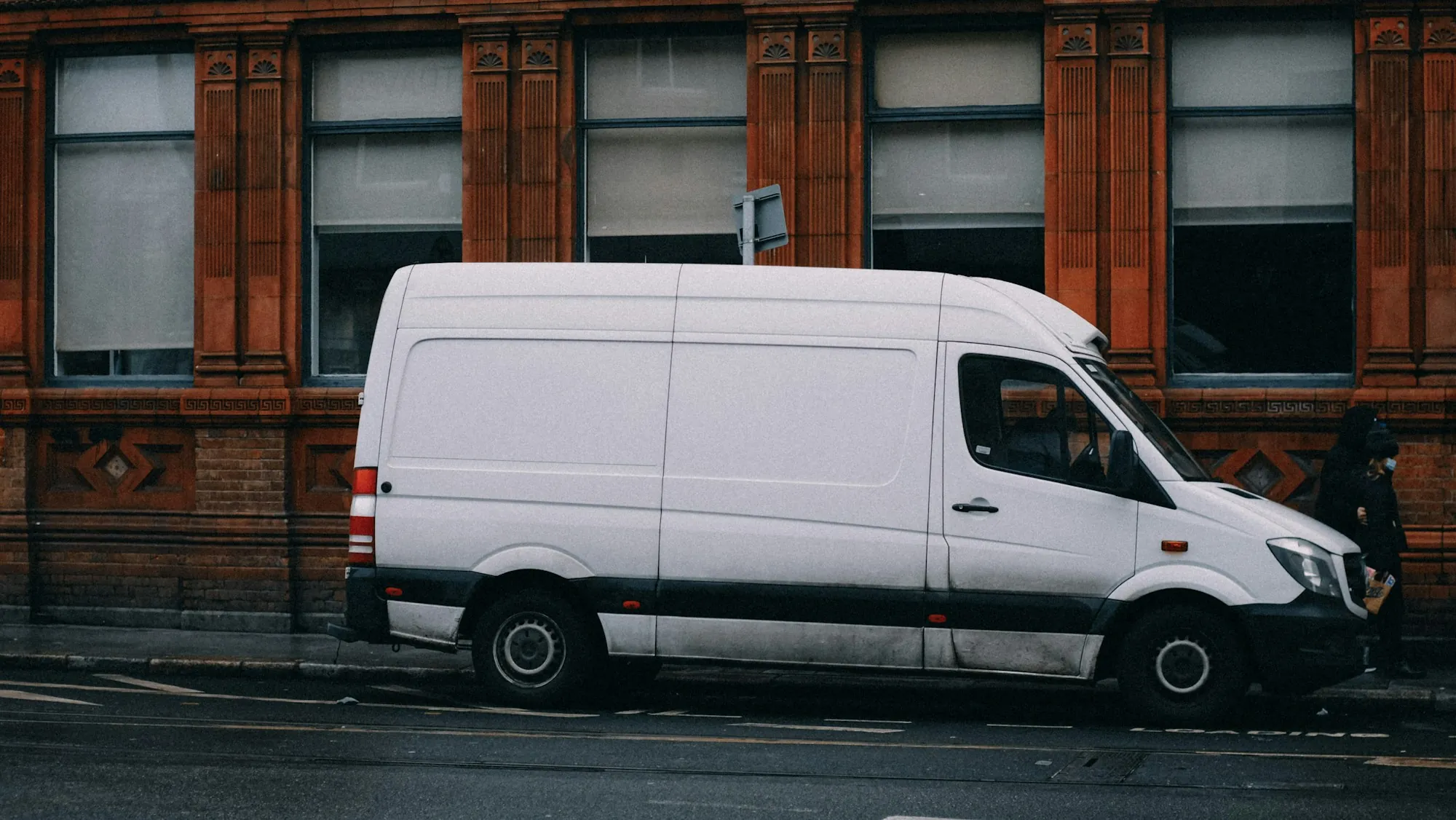 White cargo van parked on a city street